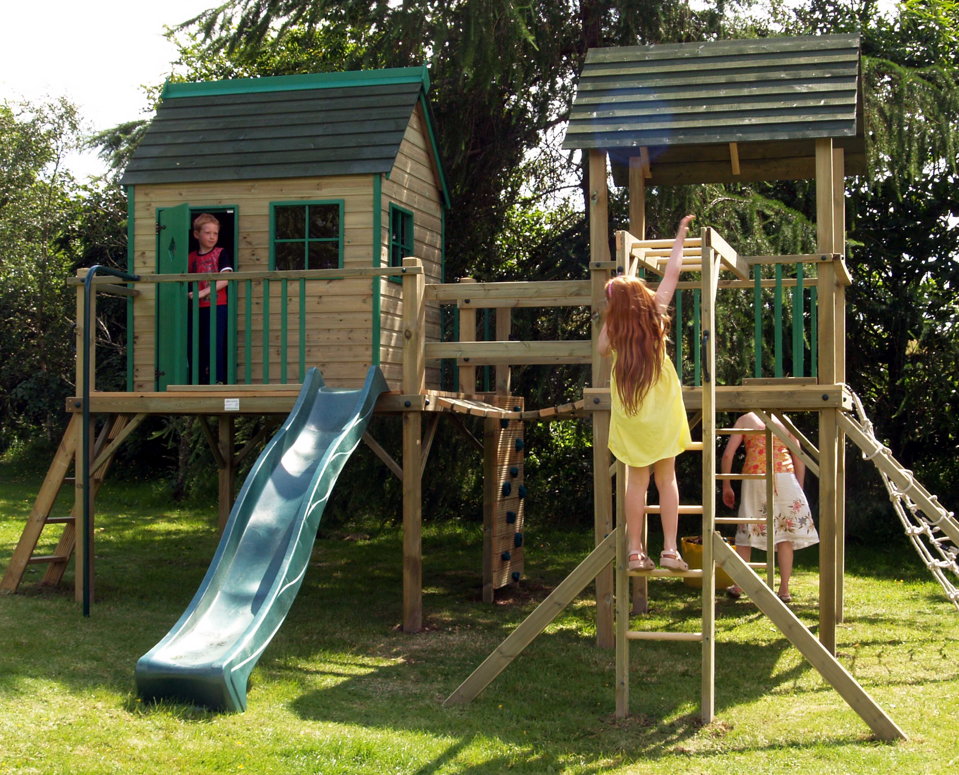 A Forest Combo playcentre in a sunny garden setting