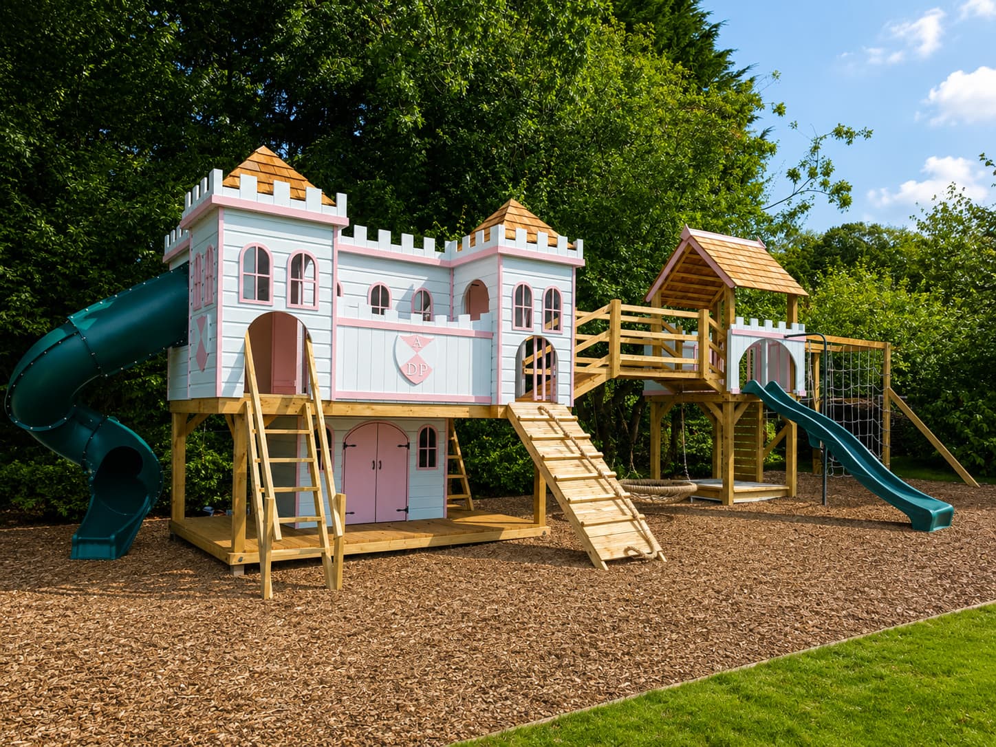 The Fantasy Castle near Bath: a two-storey monogrammed castle playhouse with spiral tube slide and bridge to its play tower
