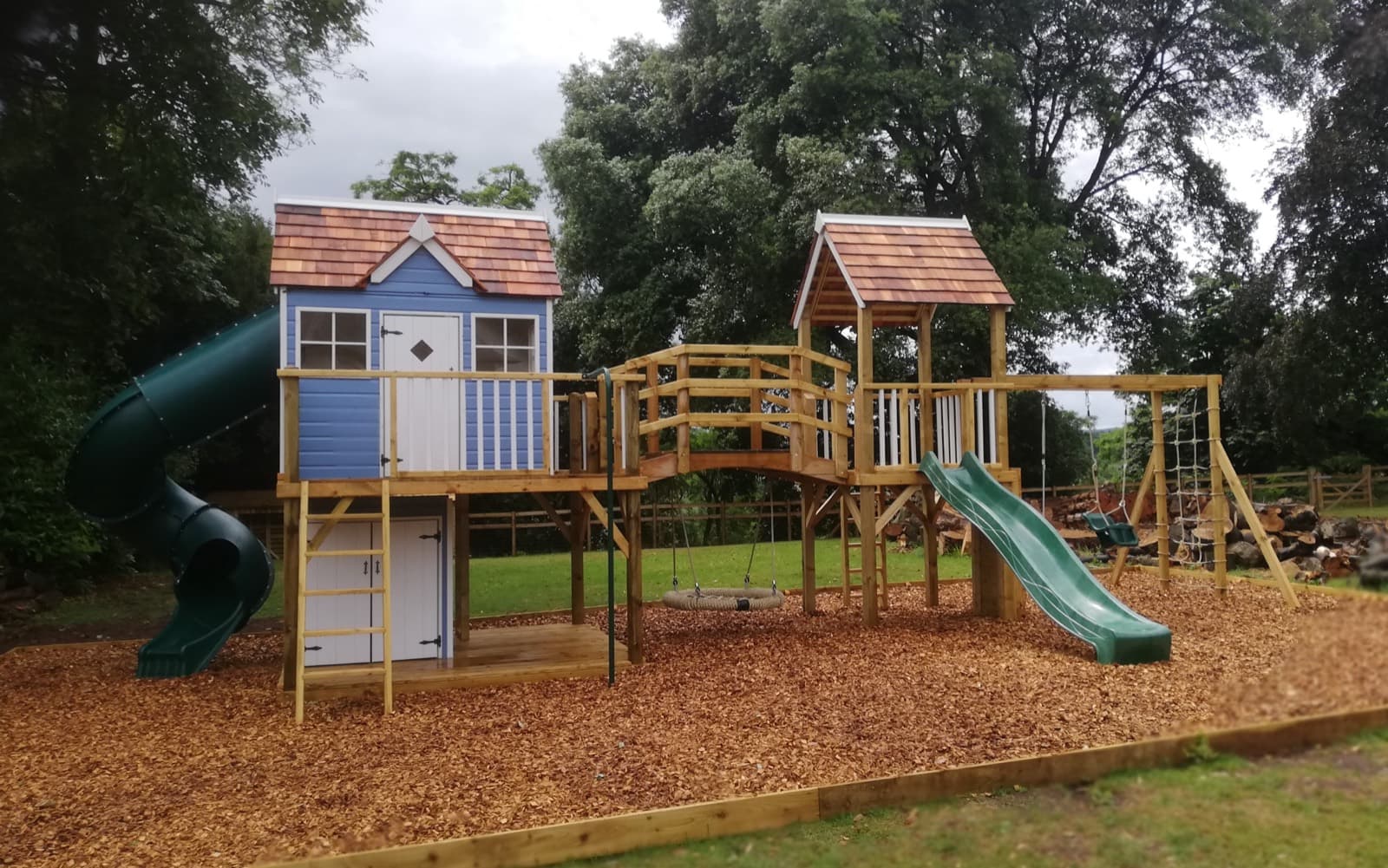 An Otter Mega Combo: the Otter cottage and lower den joined by a clatter bridge to a second play tower, with a turbo tube slide and scramble nets