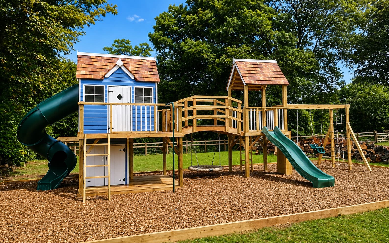 An Otter Mega Combo: the blue and white Otter Cottage with cedar shingles, tube slide, hump bridge, and second tower