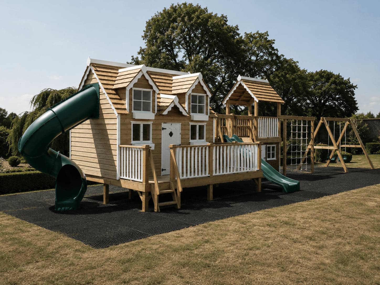 A Harvestwood House with cedar shingle roof and dormers, joined to a play tower with a tube slide