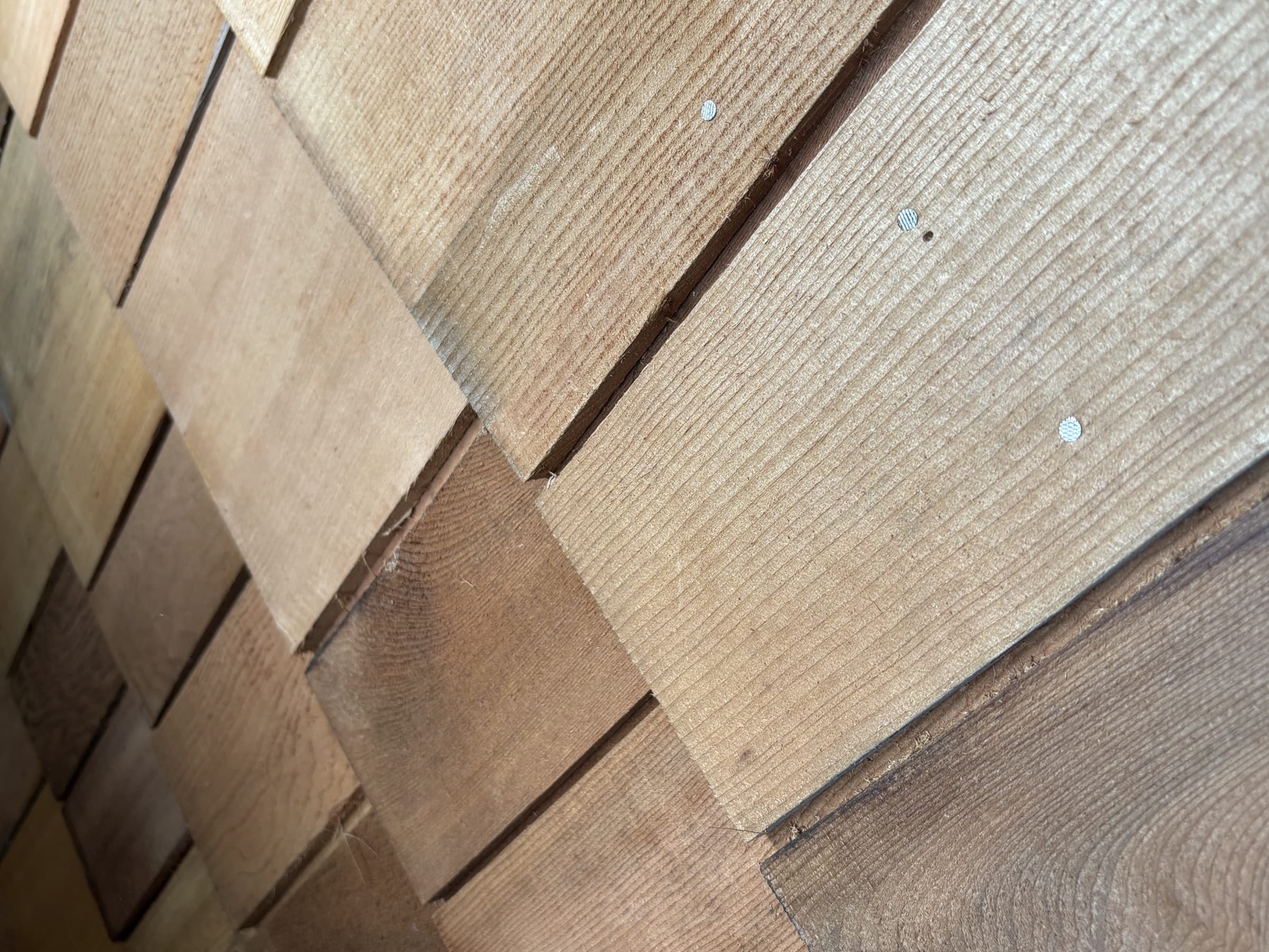 Close-up of overlapping cedar shingle courses on a BESPOKE roof